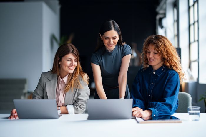Professors collaborating by a computer